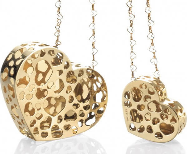 Cookie-cutter heart motifs and heart-shaped open links repeat the central motif of this gold pendant from Nanis
